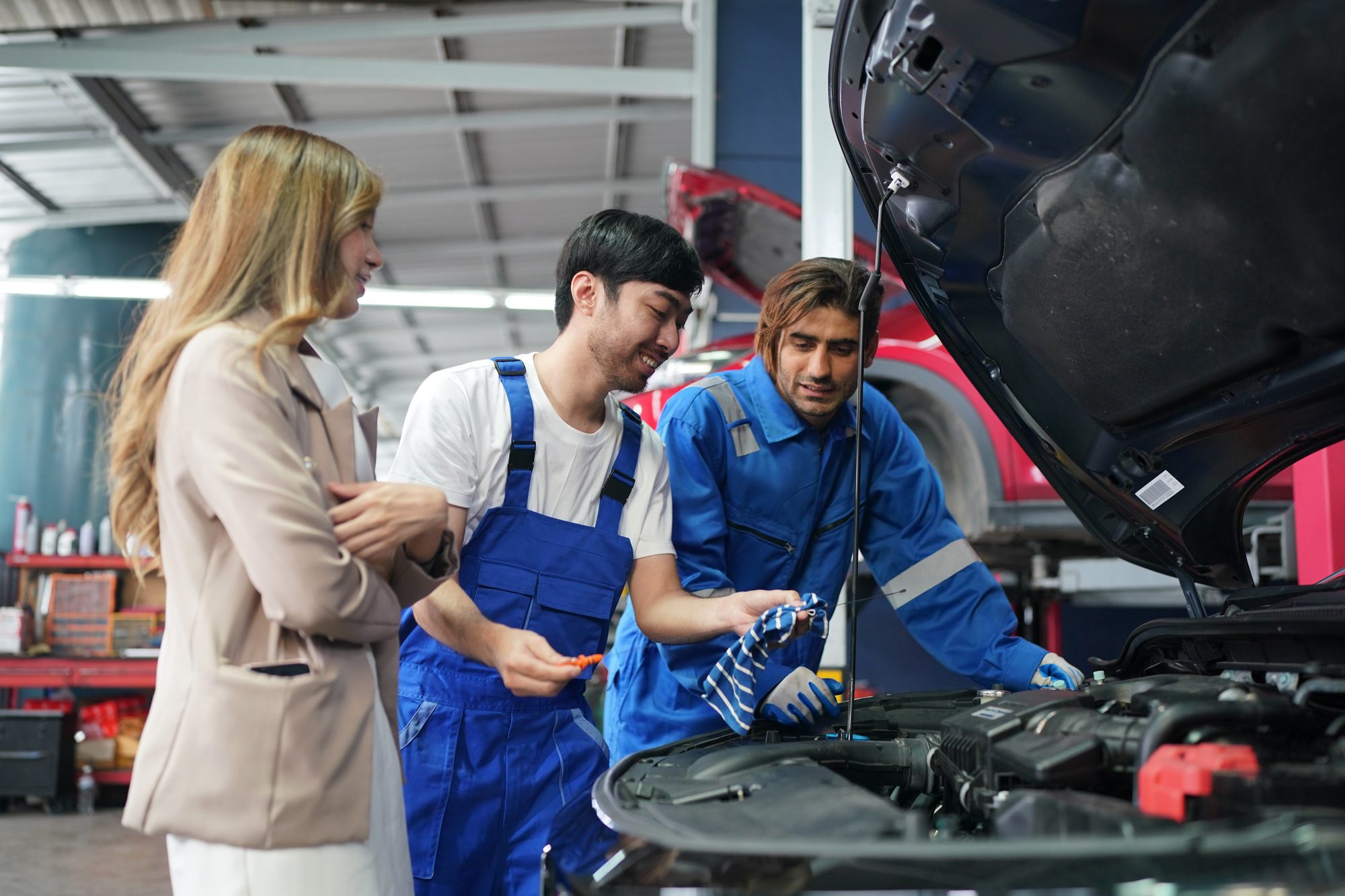 Acasă 7 mechanic in blue overalls checking serviceability of car engine